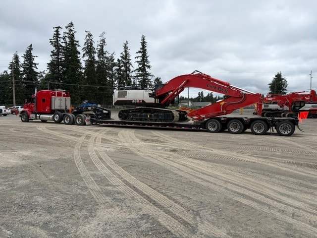 Flatbed truck with oversize load on highway
