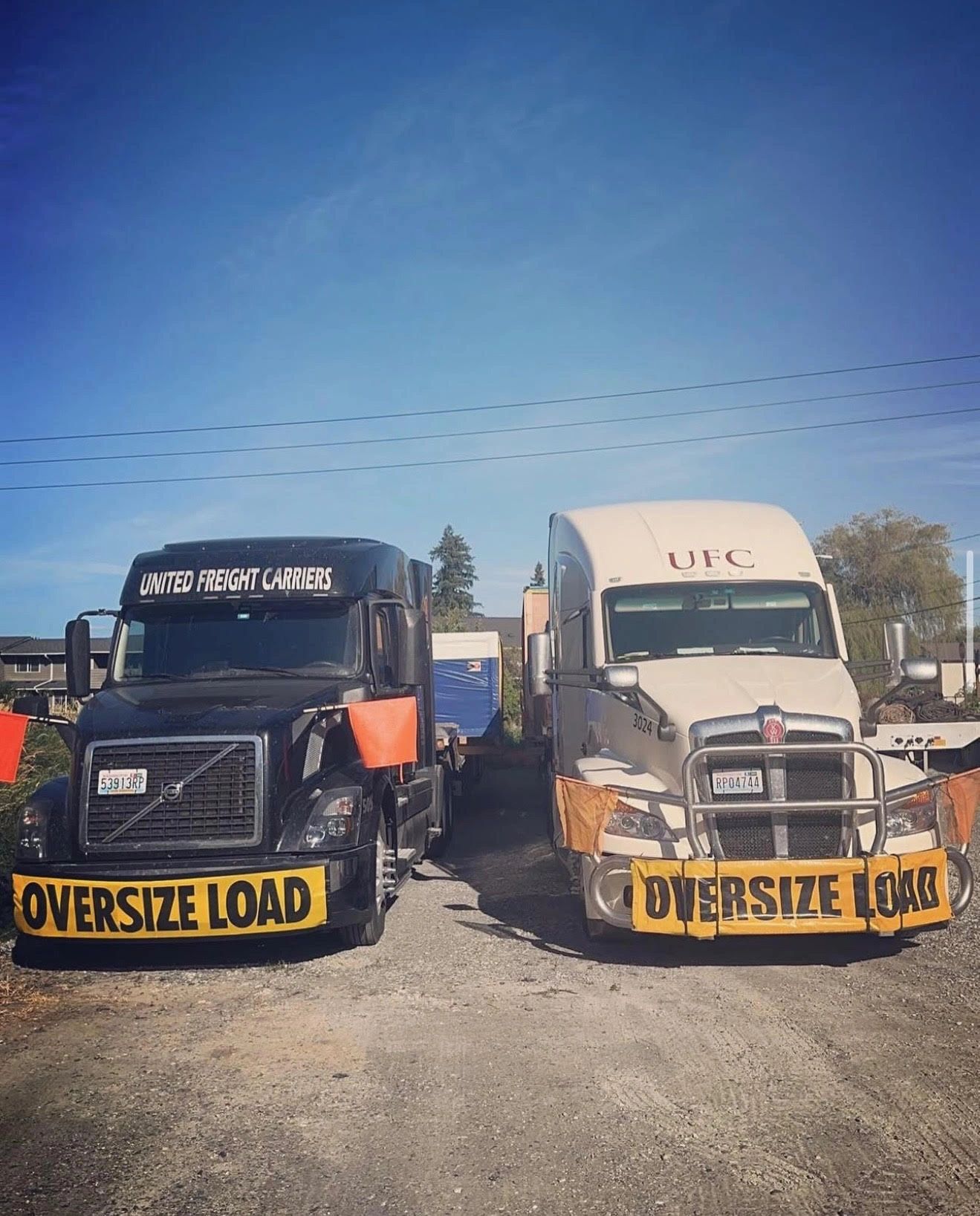 United Freight Carriers trucks with oversize load signs
