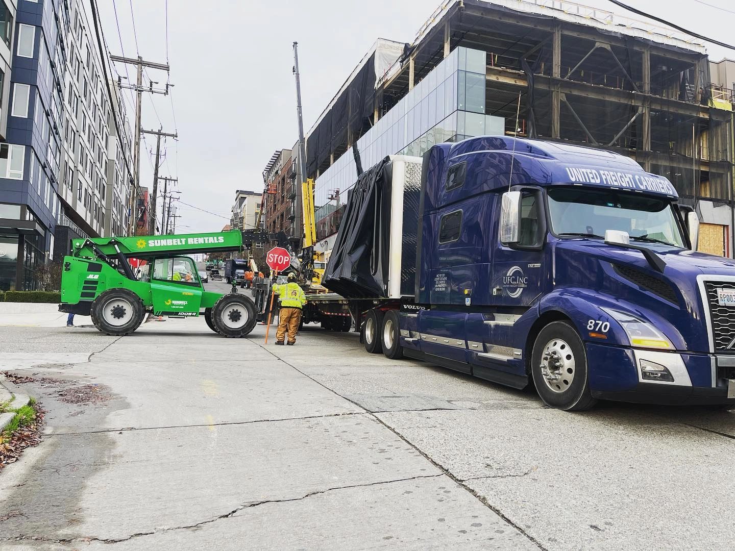 UFC truck being loaded by aerial lift in urban setting