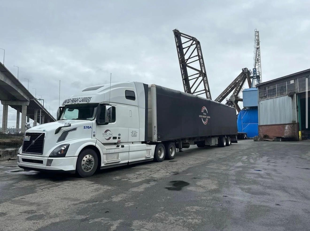 United Freight Carriers white Volvo truck at port